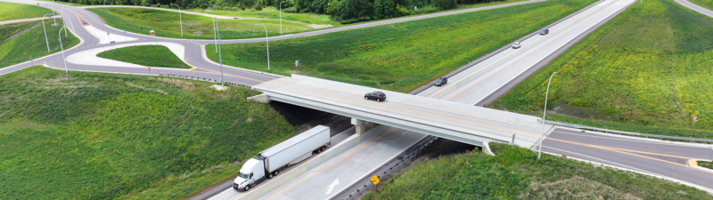 Structures - Alliant Engineering. Photo of cars going under a bridge on a highway.